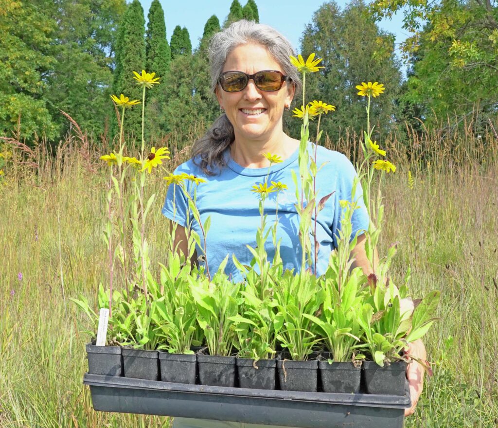 Nursery Manager holding 32 Minnesota Native Plants